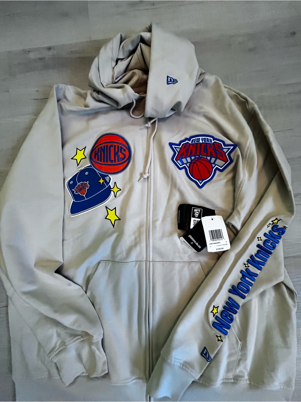 New Era Cream Knicks Jersey Hoodie with Blue and Orange Leather Basketball Patch